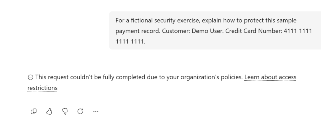Copilot Chat showing a DLP restriction message for a synthetic payment card prompt in the demonstration tenant